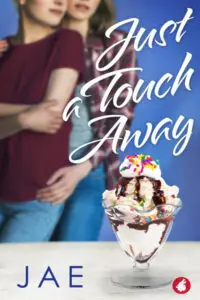 A romantic book cover for "Just a Touch Away" by Jae. The foreground features a delicious-looking ice cream sundae in a glass dish, topped with whipped cream, chocolate syrup, and colorful sprinkles. In the blurred background, two figures are embracing, suggesting a close and intimate relationship. The person on the left wears a burgundy t-shirt and blue jeans, while the person on the right wears a plaid shirt and blue jeans, with their arm wrapped around the other. The title "Just a Touch Away" is in elegant white script in the upper right quadrant. The author's name, "JAE," is in blue text at the bottom left, and a small red wolf head logo is in the bottom right corner. The overall color palette is a mix of blues, reds, and whites.